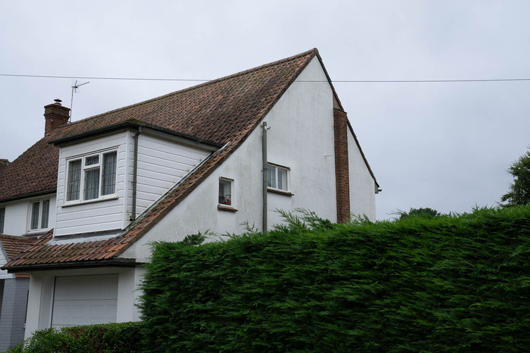Render side gable showing fully restored clean finish after professional soft wash treatment with no algae or staining remaining